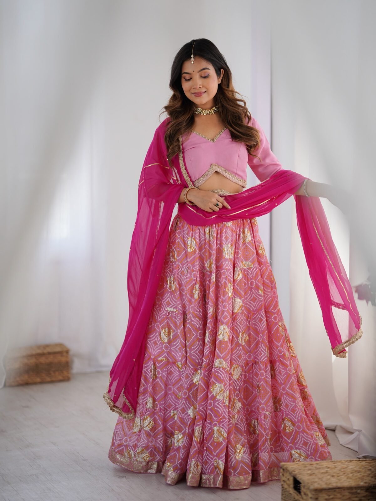 Pink tiered lehenga with blouse and magenta dupatta