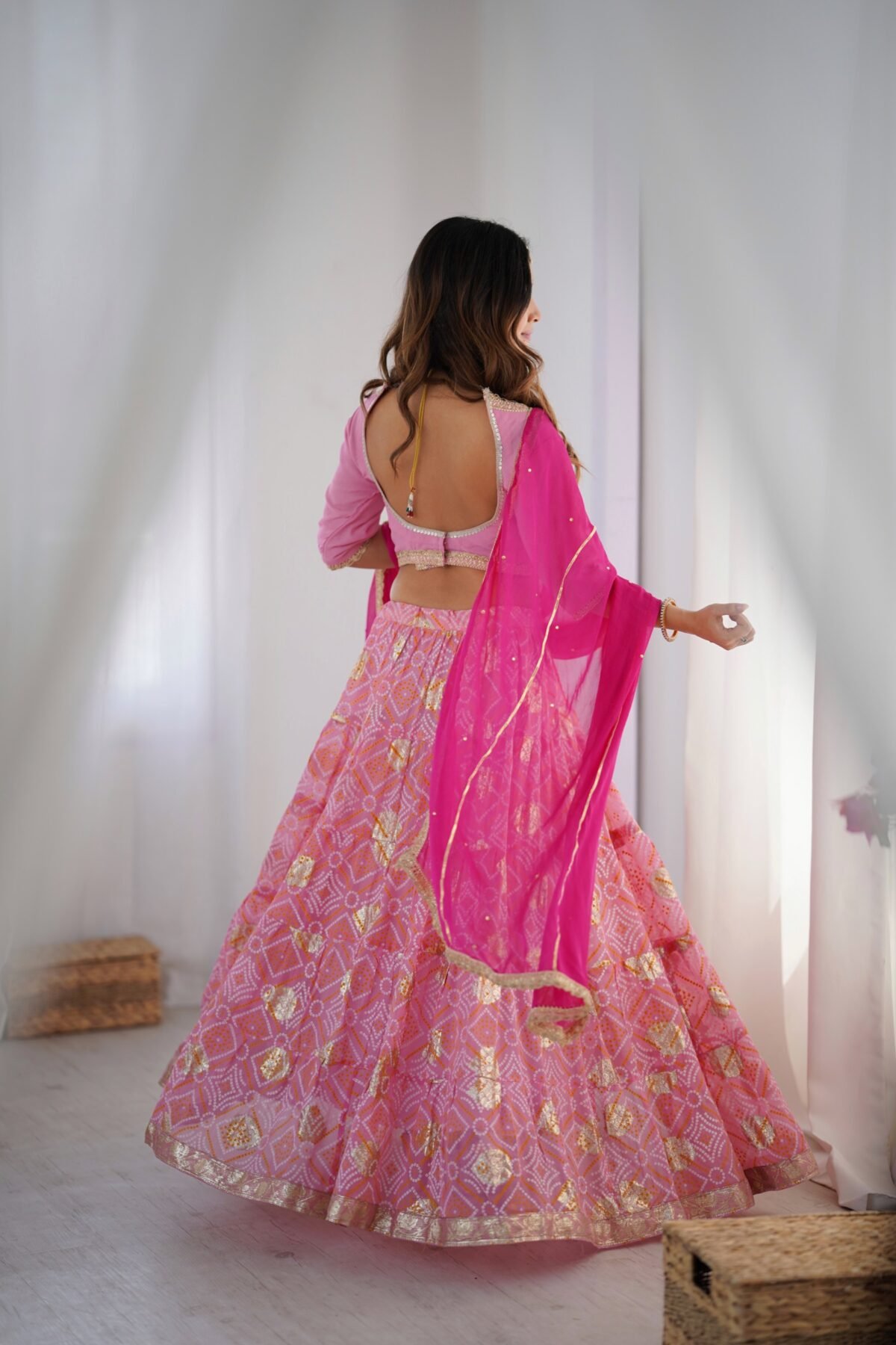 Pink tiered lehenga with blouse and magenta dupatta