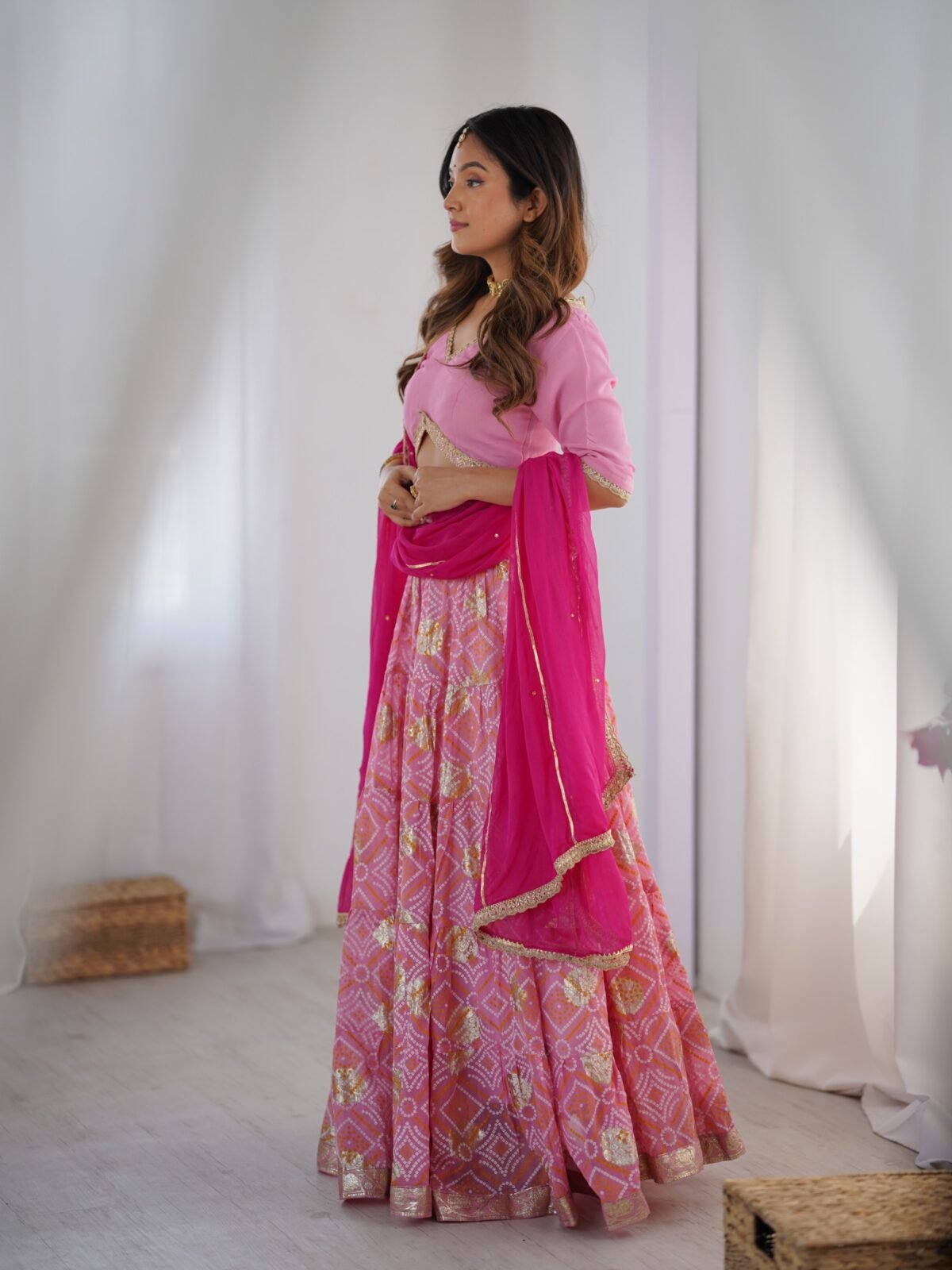 Pink tiered lehenga with blouse and magenta dupatta