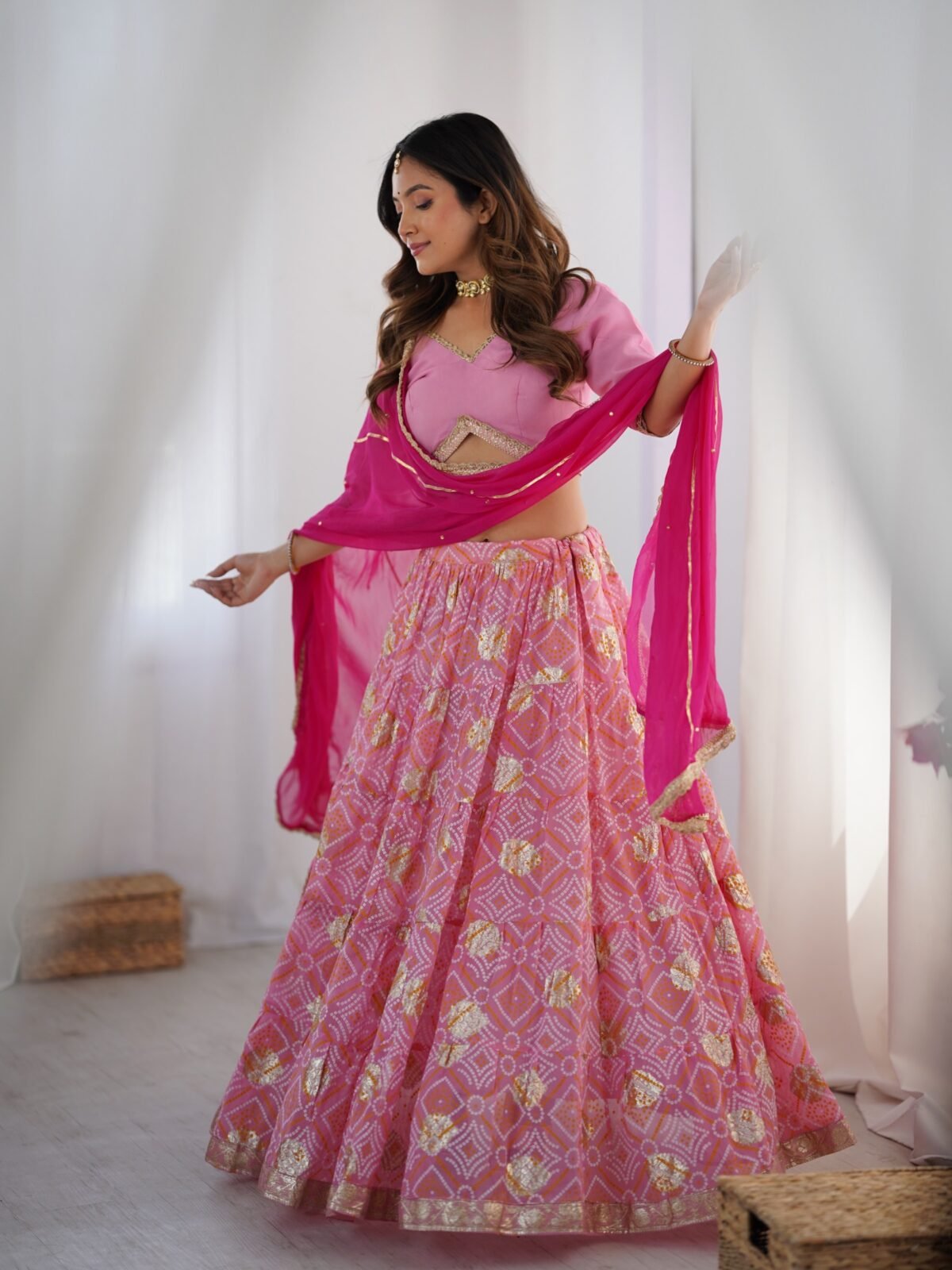 Pink tiered lehenga with blouse and magenta dupatta