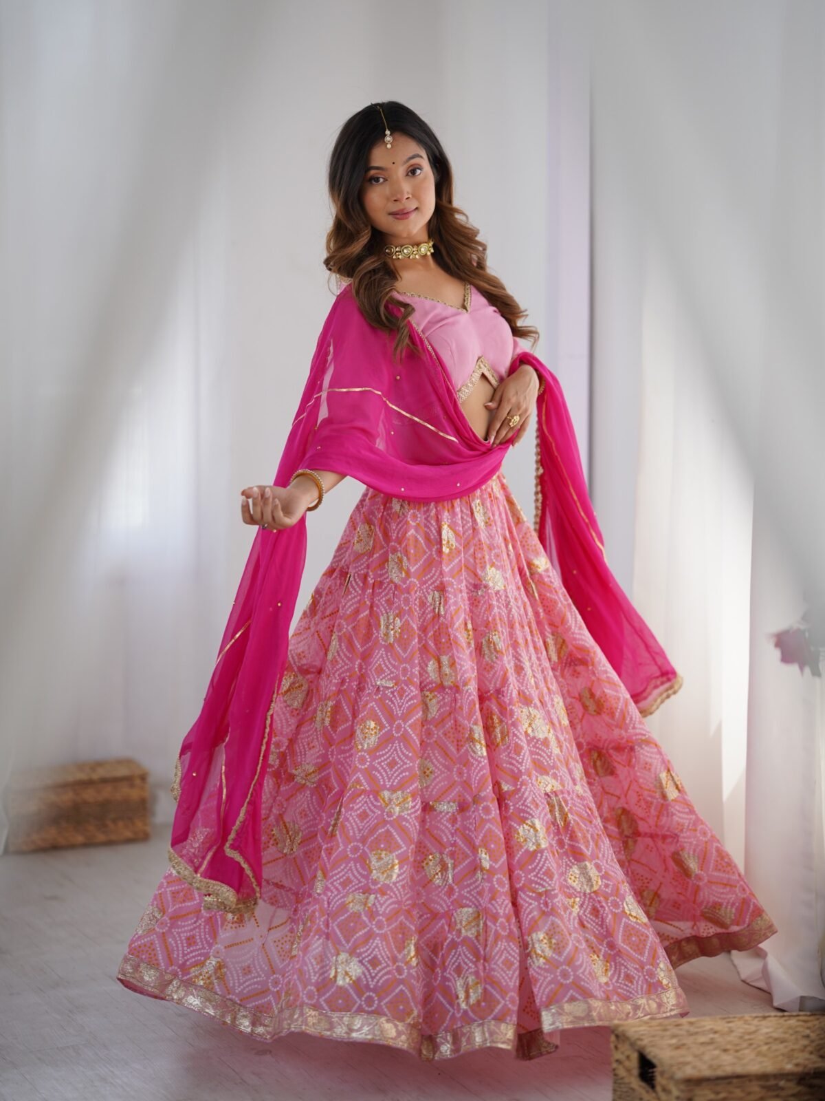 Pink tiered lehenga with blouse and magenta dupatta