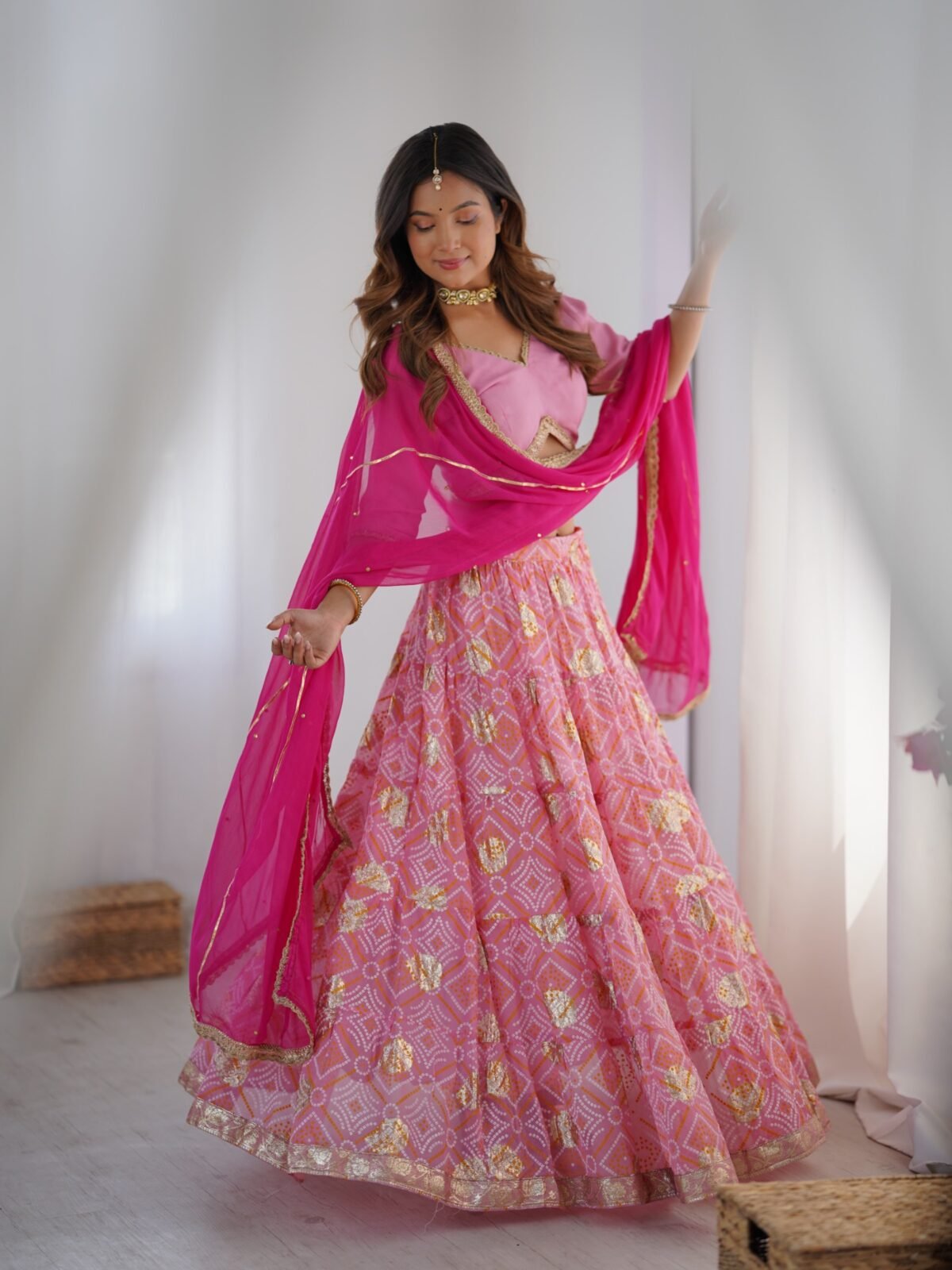 Pink tiered lehenga with blouse and magenta dupatta