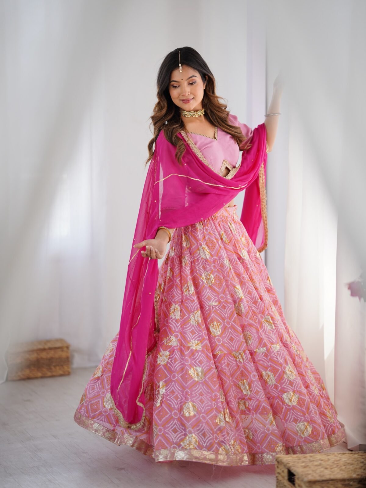 Pink tiered lehenga with blouse and magenta dupatta