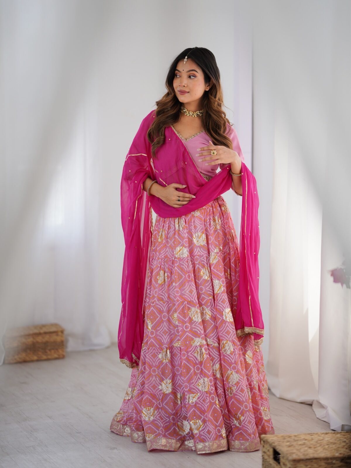 Pink tiered lehenga with blouse and magenta dupatta