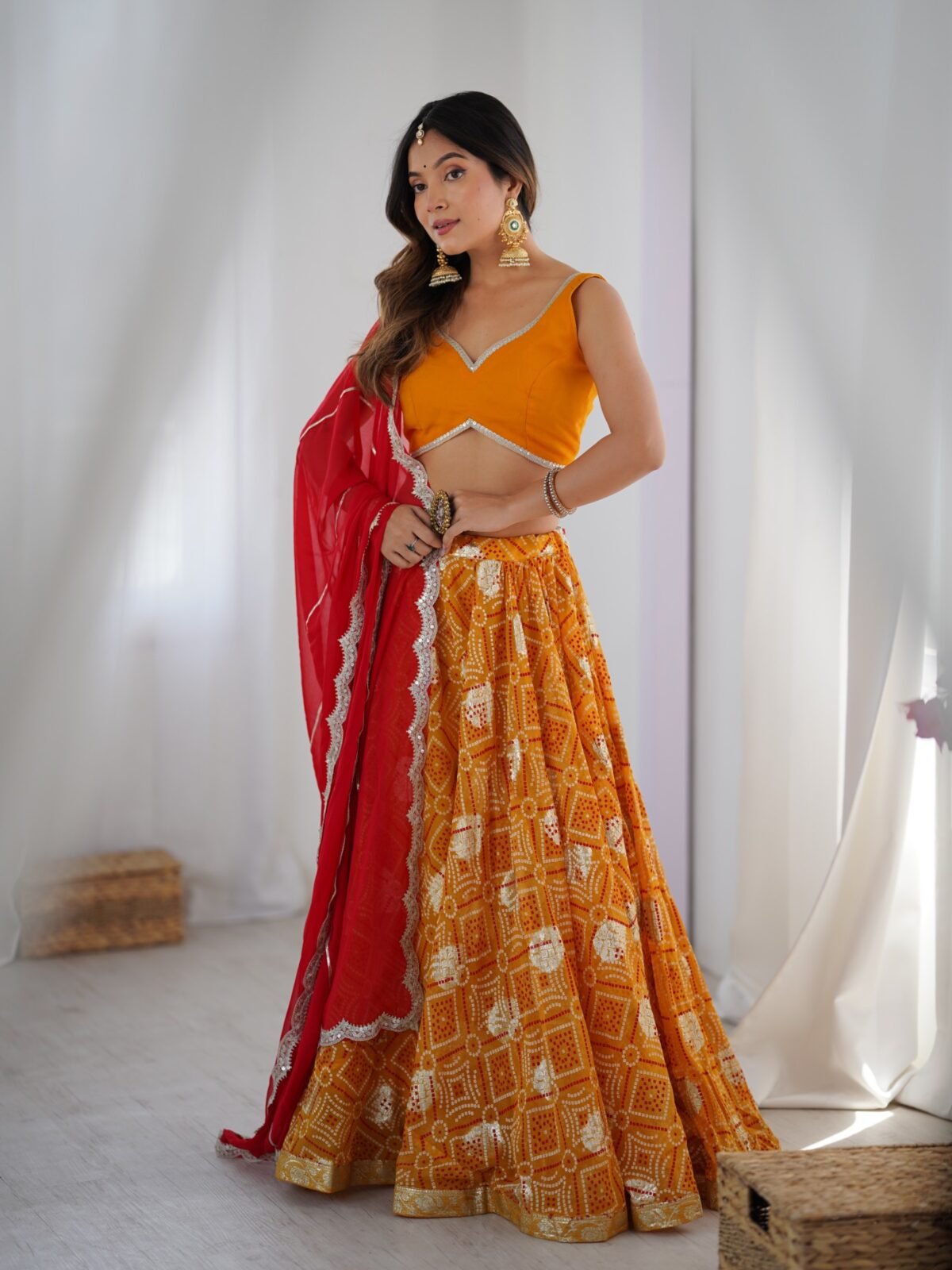 Yellow bandhani printed lehenga with blouse and red dupatta