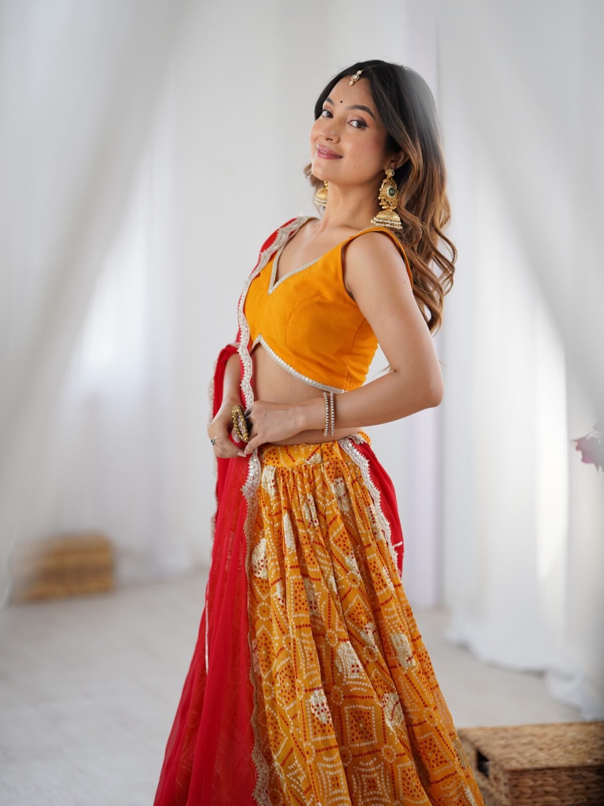 Yellow bandhani printed lehenga with blouse and red dupatta