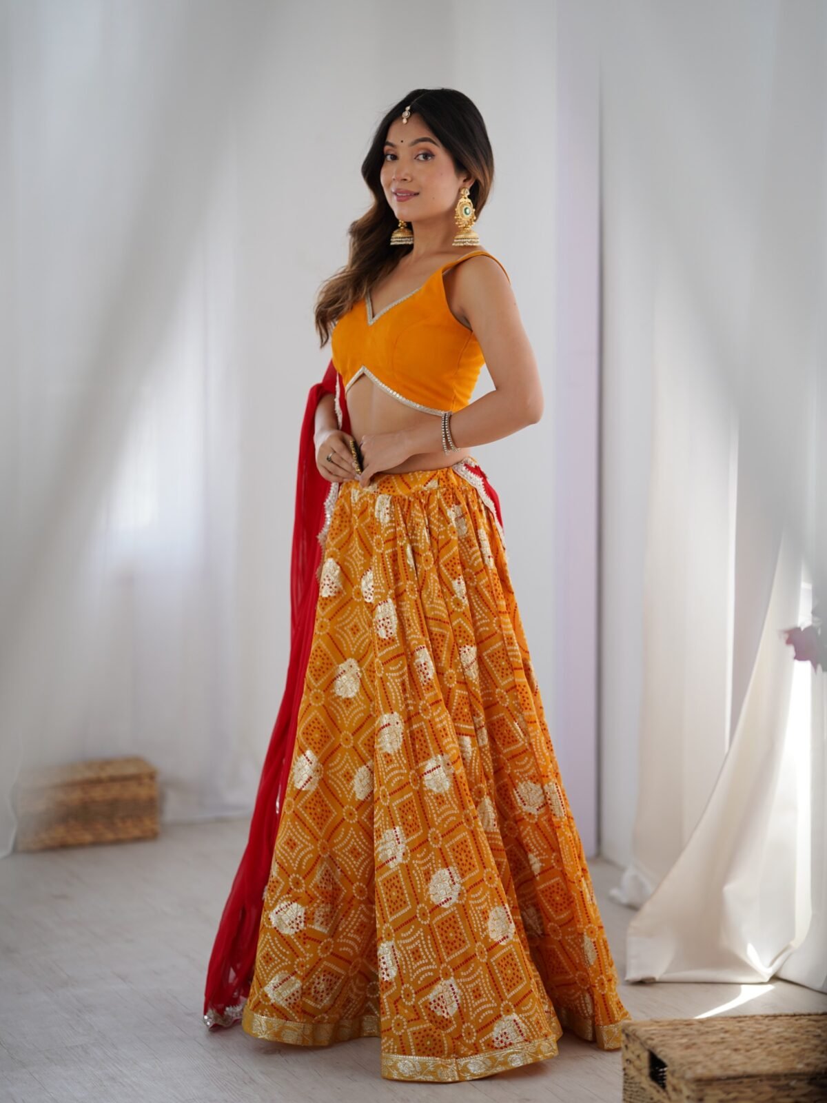 Yellow bandhani printed lehenga with blouse and red dupatta