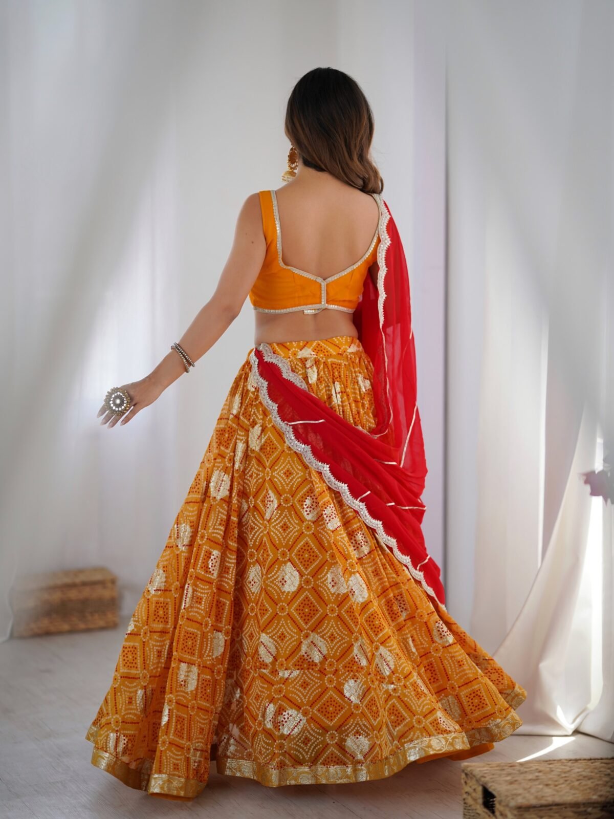 Yellow bandhani printed lehenga with blouse and red dupatta
