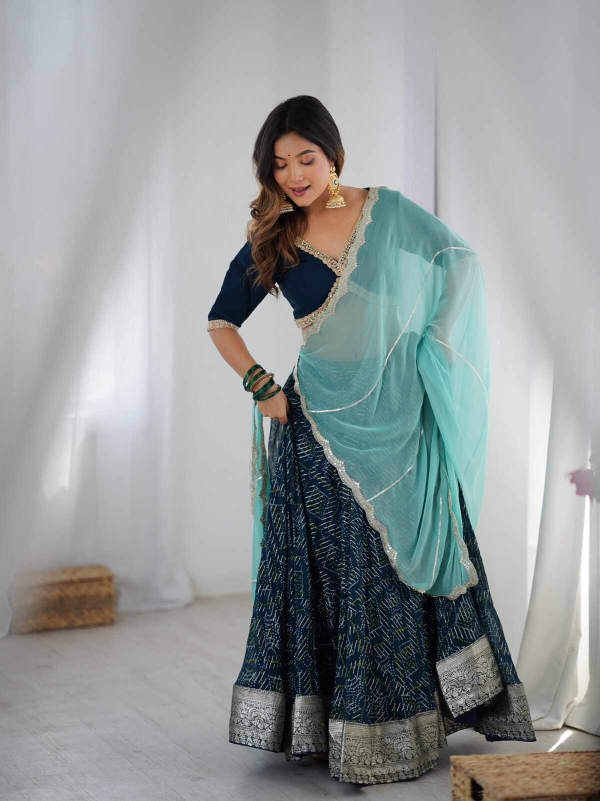 Teal blue lehenga with blouse and powder blue dupatta