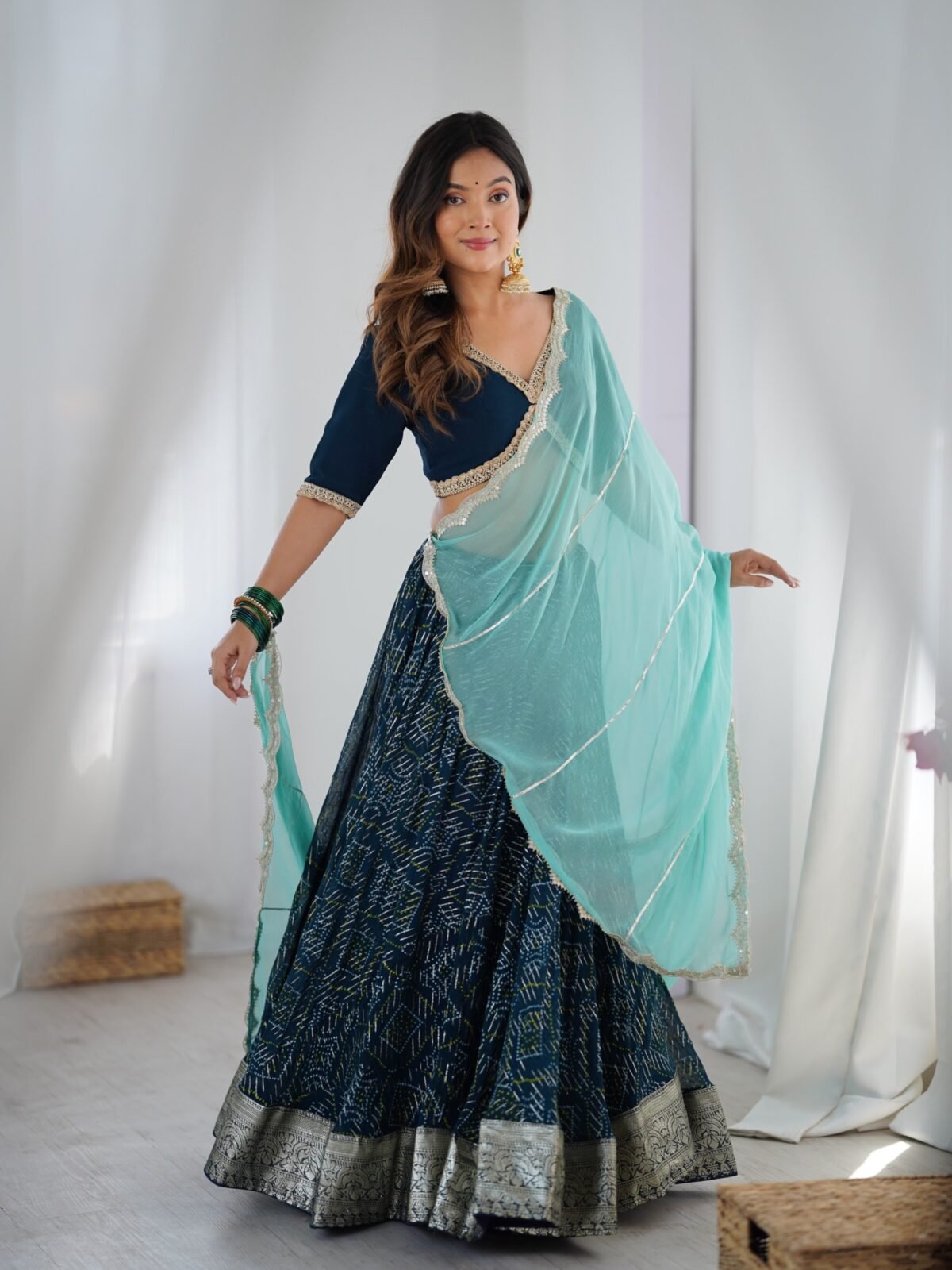 Teal blue lehenga with blouse and powder blue dupatta