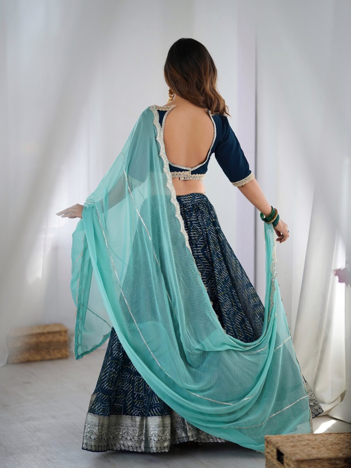 Teal blue lehenga with blouse and powder blue dupatta